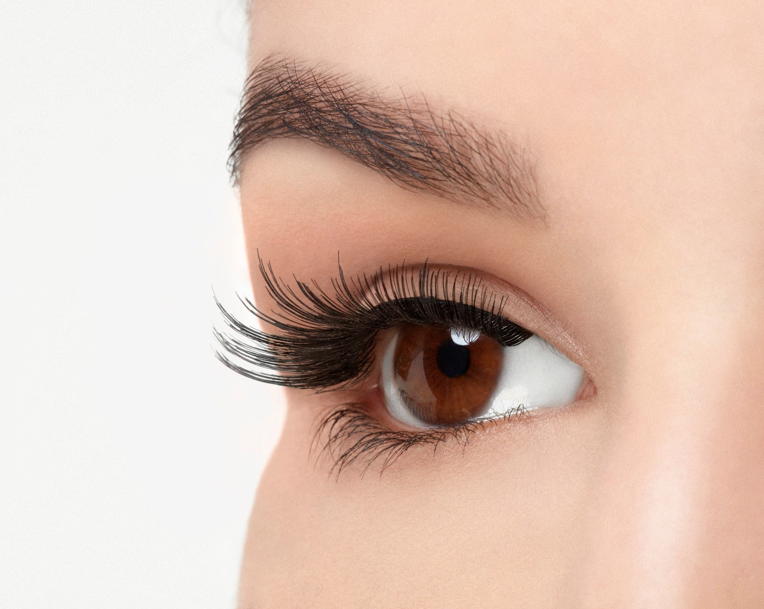 Angled close-up of a model's open right eye wearing an Ardell Natural 106 faux lash showing off spiky ends