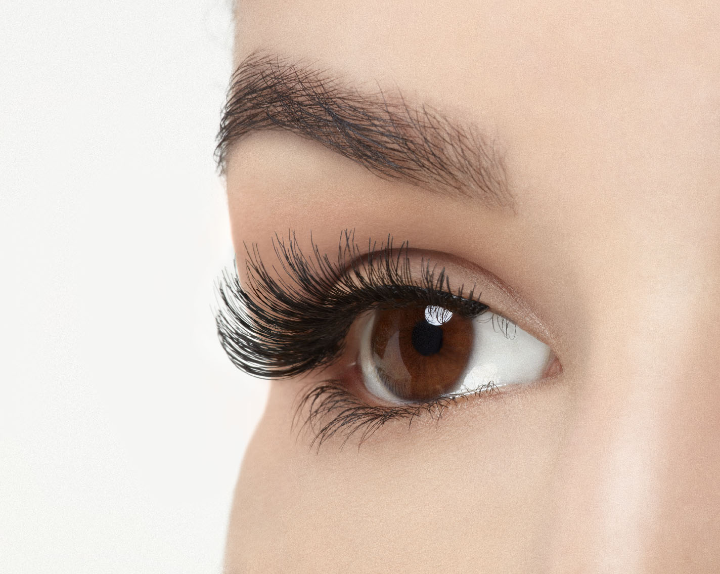 A model with an open eye wearing Ardell Studio Effects Demi Wispies showing its flared, curly & natural lash look