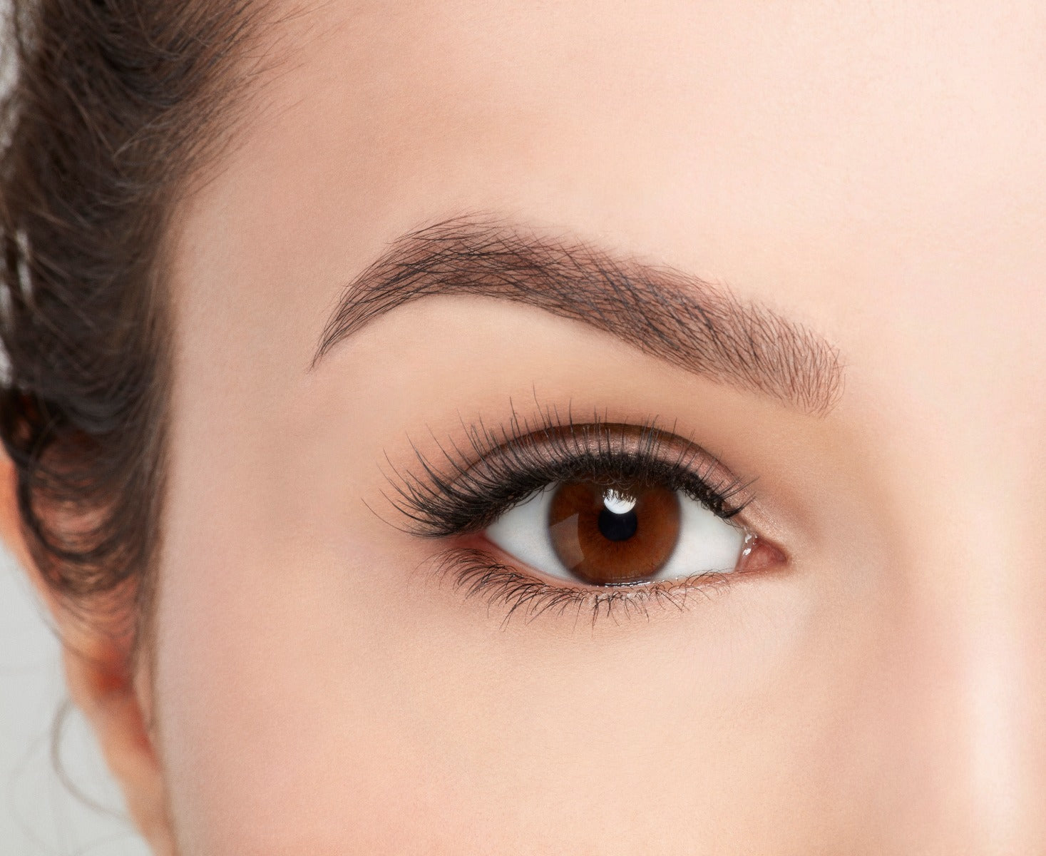 Model with open right eye wearing Ardell Pre-Cut Lashes 900 showing how it looks flared & natural on the eye