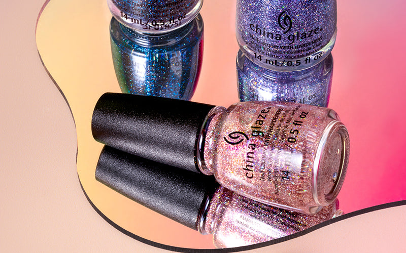 Two bottles of China Glaze nail polish on a reflective surface with a gradient background.