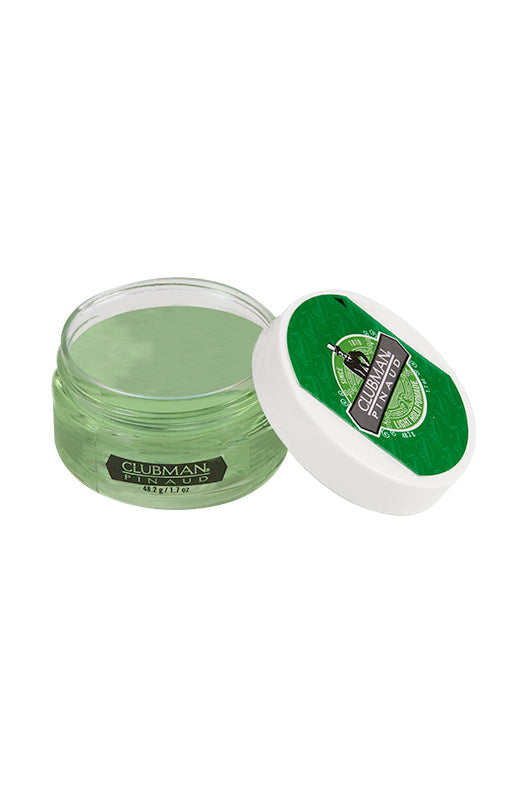 Open 1.7 ounce jar of Clubman Light Hold Pomade showing its rich green colored contents with lid resting on its left side 