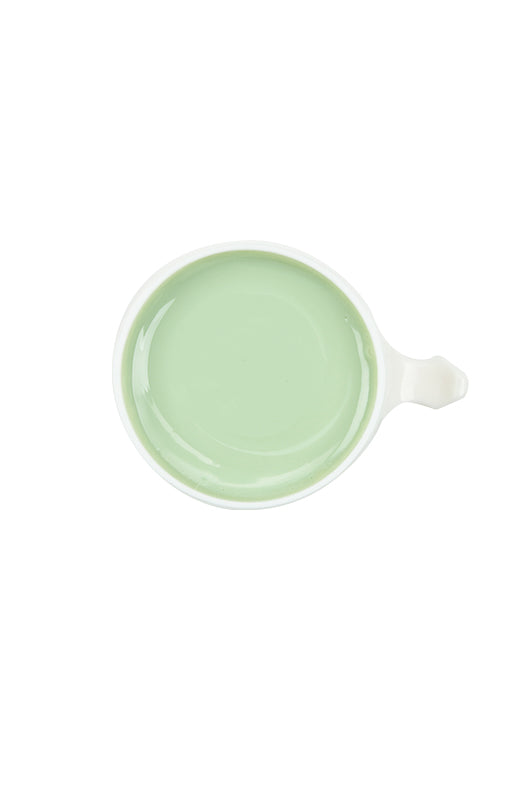 Top view of GiGi Brazilian Bikini Wax Microwave bottle uncapped showing its creamy pastel green wax contents