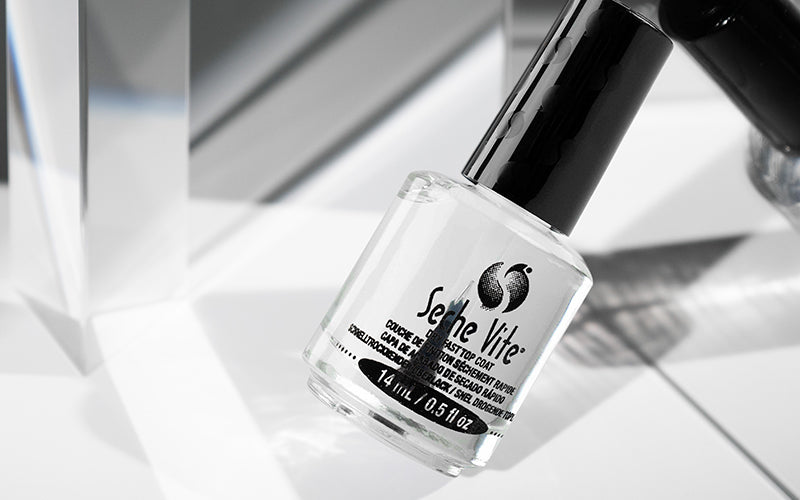 Seche Vite Dry Fast Top Coat nail polish in clear glass bottle with black cap on a clean white background