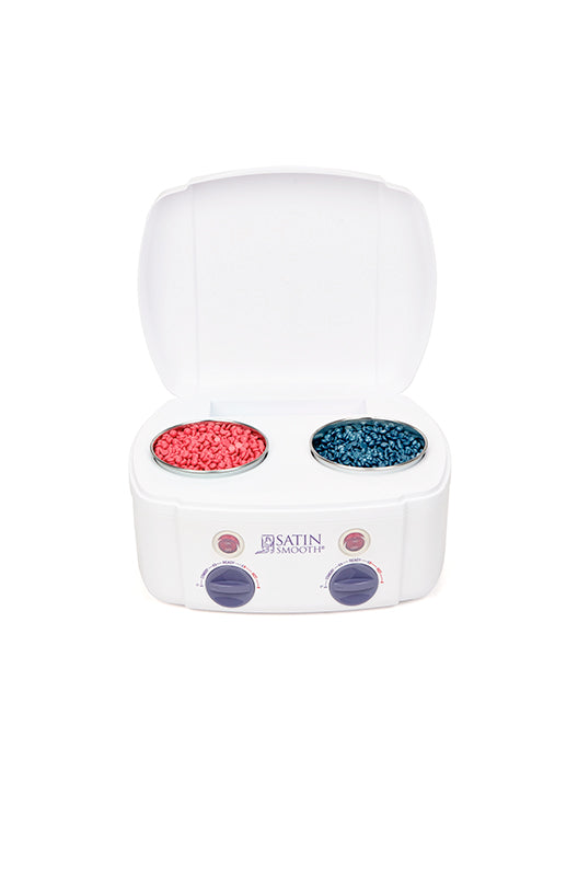 An expansive view of double wax warmer with cherry red and titanium blue wax beans inside while heating the wax