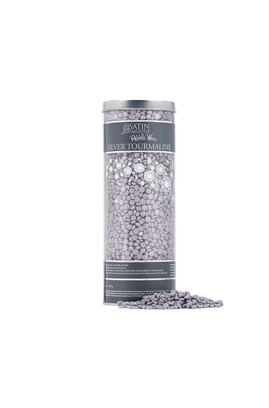 Expansive view of a tall transparent container label detail design with solid pearly silver-gray color wax beans outside